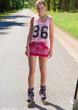 Young blonde girl Faina gets naked in middle of road wearing roller blades