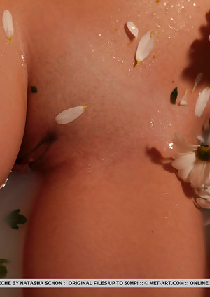 Sultry teen Valery Leche gets into a petal filled tub after removing lingerie