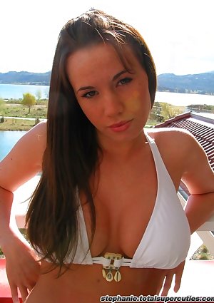 Busty brunette teen in a white bikini