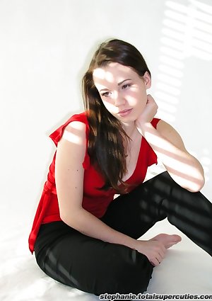 Steph poses in her red top in a studio